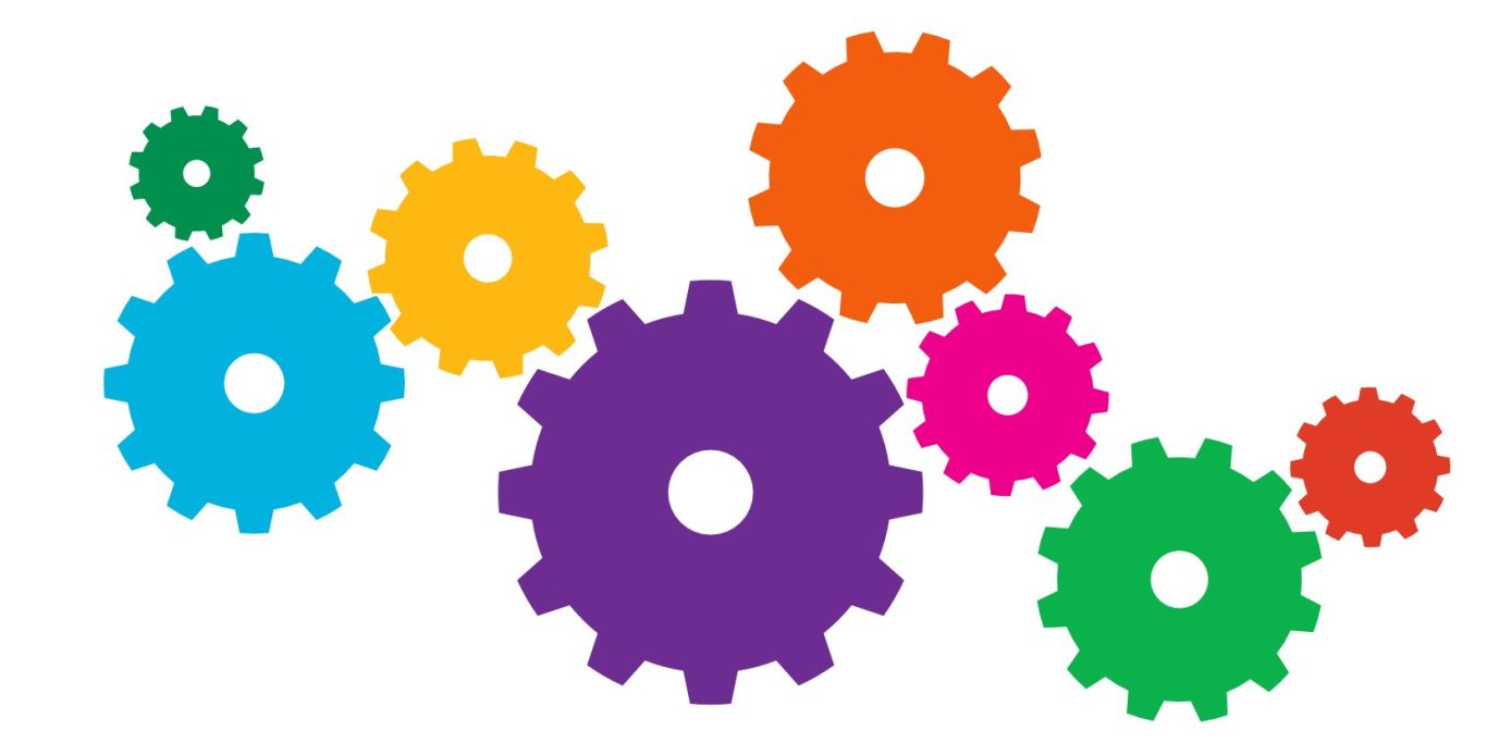 Bunte Zahnräder in verschiedenen Größen, angeordnet.