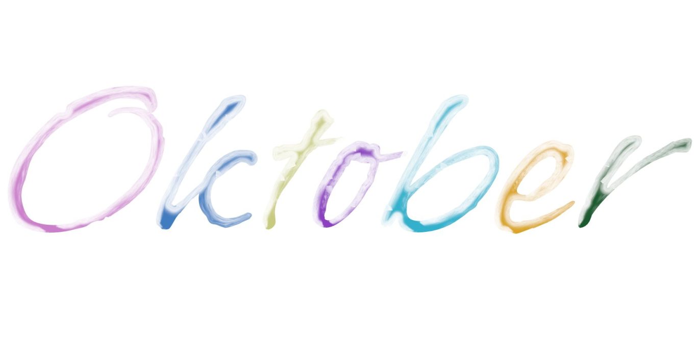 Der Schriftzug „Oktober“ in bunten, aquarellartigen Buchstaben.