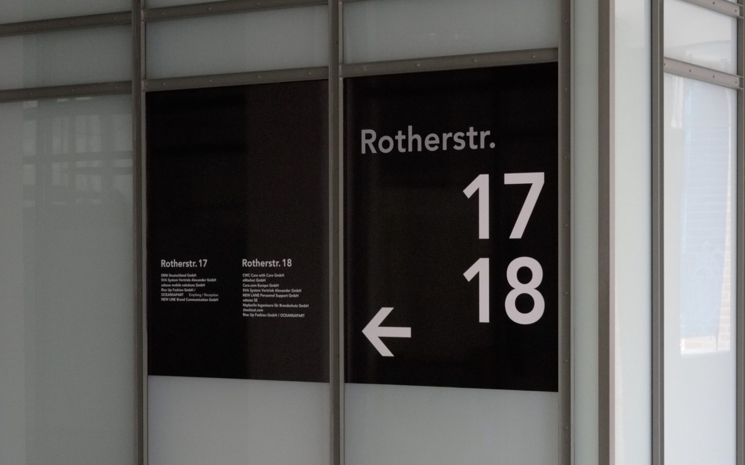 Orientierungstafel mit Wegweisungen zu Rothenstraße 17 und 18, Pfeil nach links.